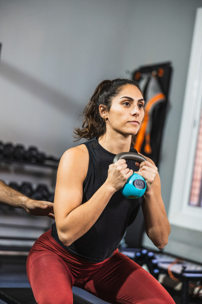 determined young woman performing kettlebell squat 2026 07 24 16 48 47 utc