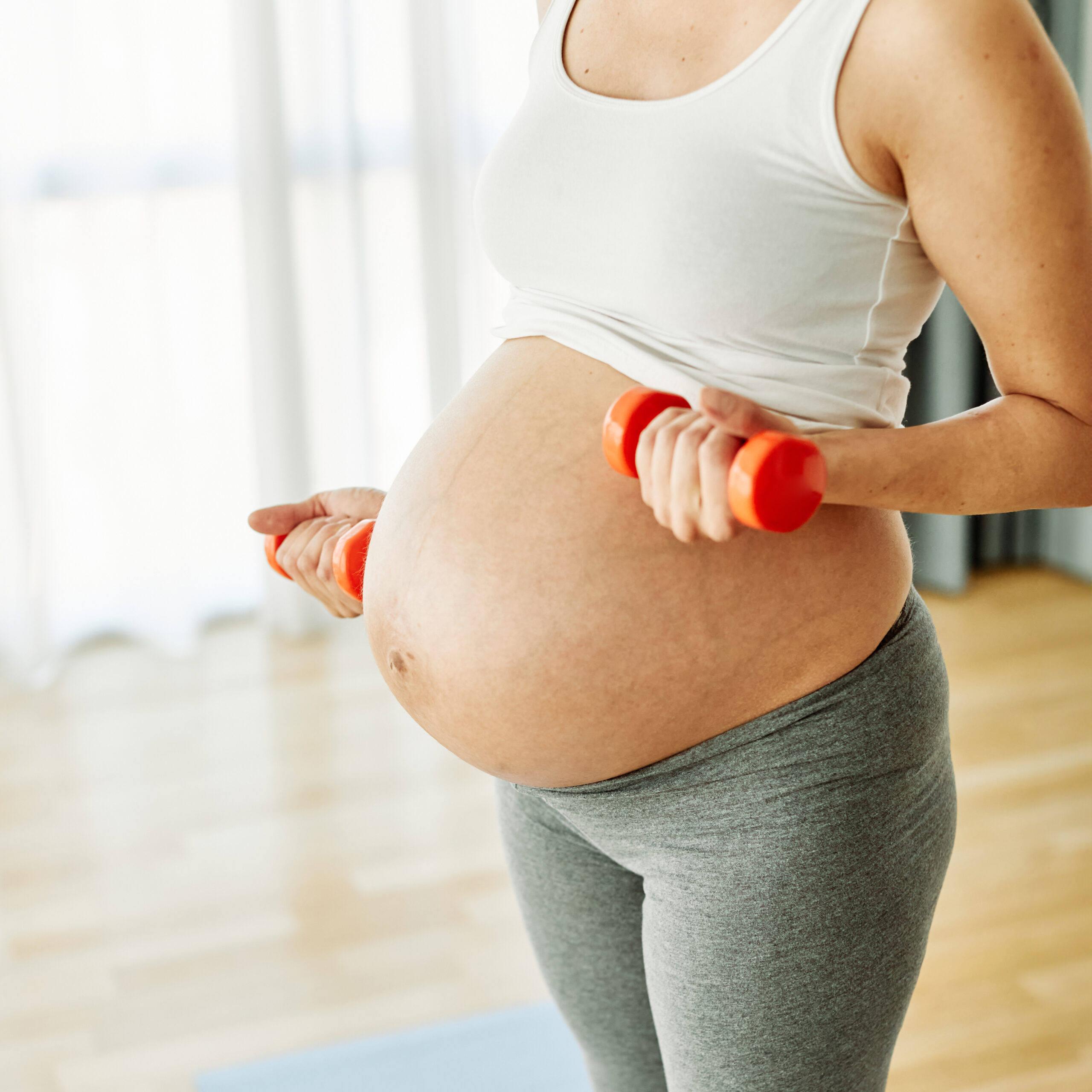 pregnant woman doing arm exercises with dumbbells 2026 01 11 10 49 55 utc